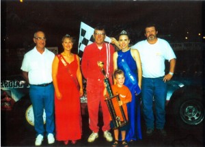 Dwight Cook, left, helped present the trophy to driver Bud Peterson, center, during the Kossuth County Fair. 