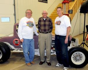 Norm Wiemers is joined by his sons Tom (right) and Bill (left). They pose next to Wiemers #38 modified, on display at our museum. 